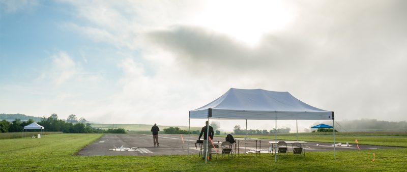 Tent set up at the foot of an airstrip as the fog lifts